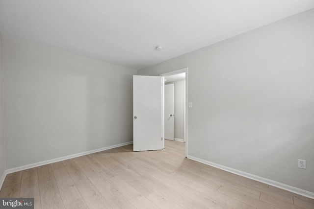 unfurnished room featuring light wood-type flooring and baseboards