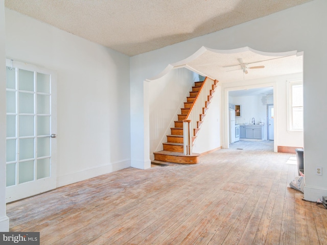 2030-32 E Somerset St, Philadelphia, PA 19134 - spare room featuring hardwood / wood-style floors, stairway, baseboards, and a textured ceiling