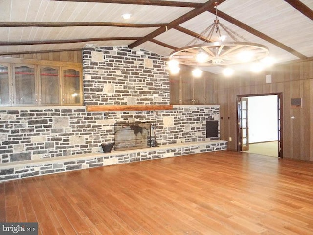 unfurnished living room with a chandelier, wood finished floors, wood ceiling, and vaulted ceiling with beams