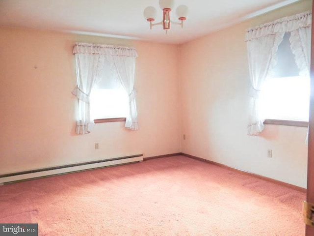 unfurnished room with baseboards, a notable chandelier, a baseboard radiator, and carpet floors