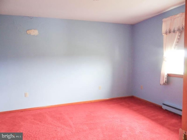 carpeted empty room with a baseboard radiator