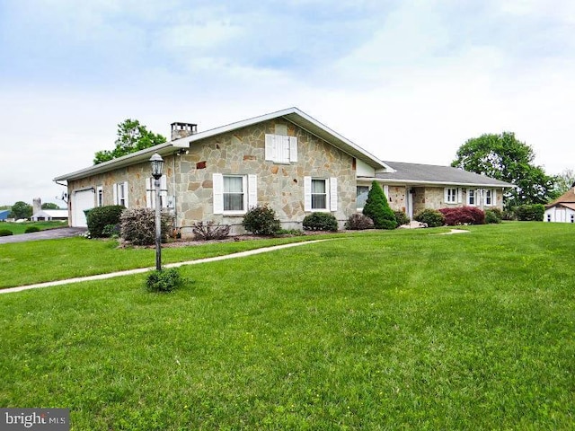 single story home featuring stone siding, driveway, a garage, and a front lawn