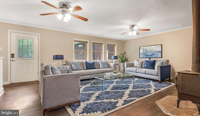 living area with a ceiling fan, crown molding, wood finished floors, and baseboards