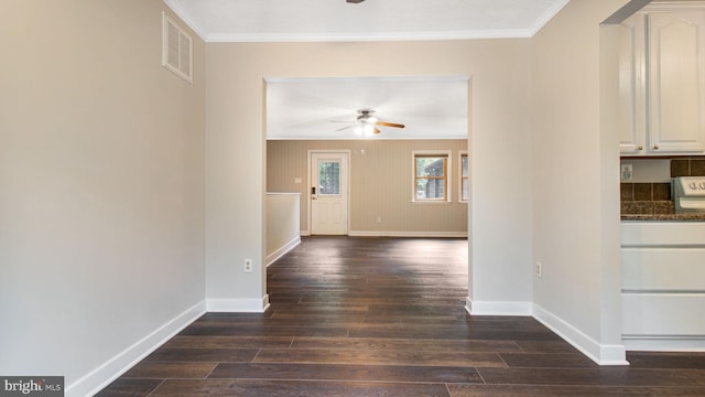 hall featuring crown molding, baseboards, and dark wood-style floors