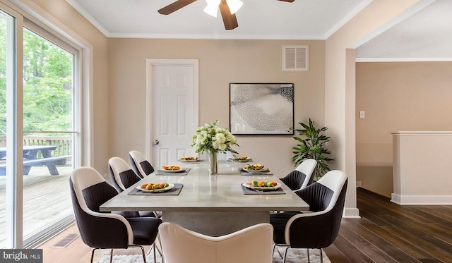 dining area with wood finished floors, a ceiling fan, baseboards, and crown molding