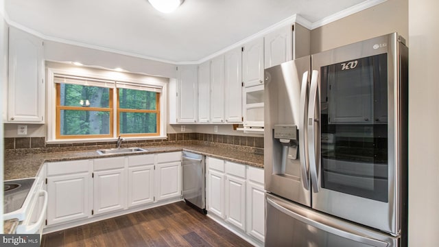 kitchen with stainless steel appliances, a sink, dark wood-type flooring, ornamental molding, and white cabinetry