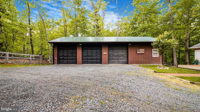 detached garage featuring fence