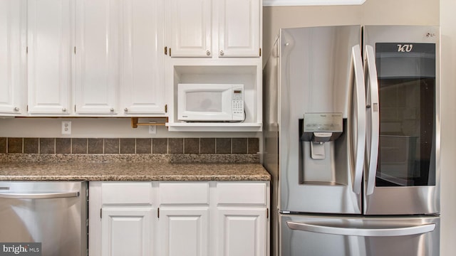kitchen featuring appliances with stainless steel finishes and white cabinetry