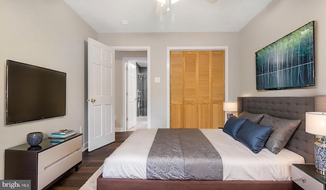 bedroom with dark wood-style floors, a closet, and baseboards
