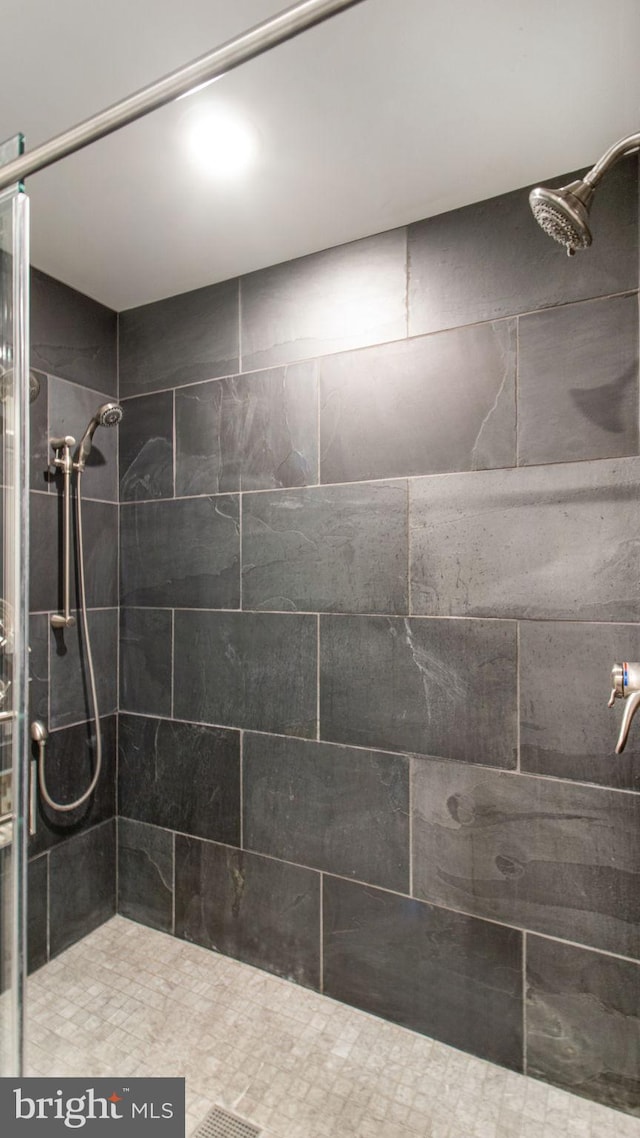 bathroom with tiled shower