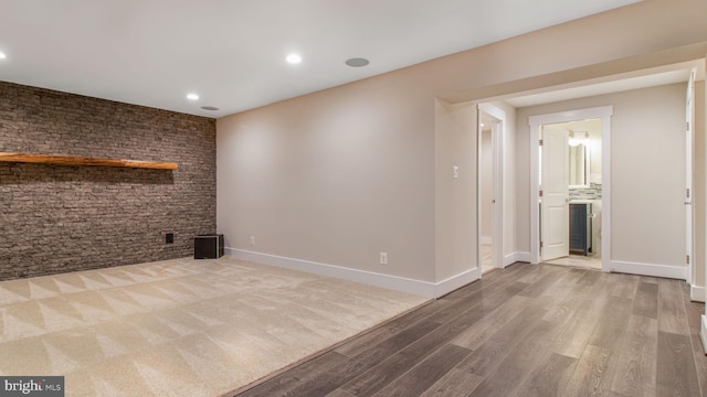 below grade area featuring wood finished floors, recessed lighting, and baseboards