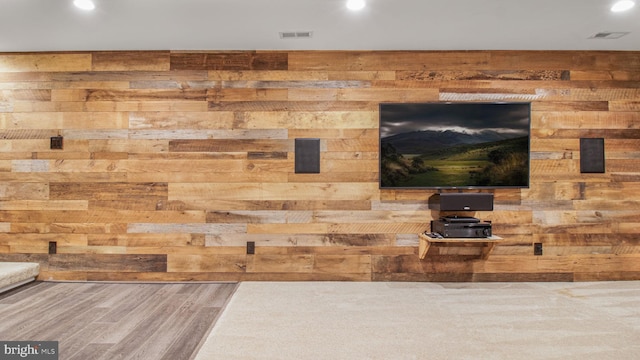 detailed view of wood walls, recessed lighting, and wood finished floors