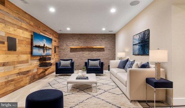 living area with recessed lighting and wooden walls