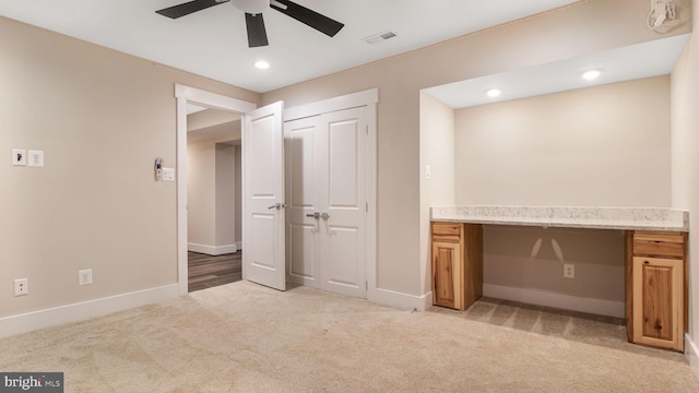 unfurnished bedroom with light colored carpet, baseboards, an office area, a closet, and recessed lighting