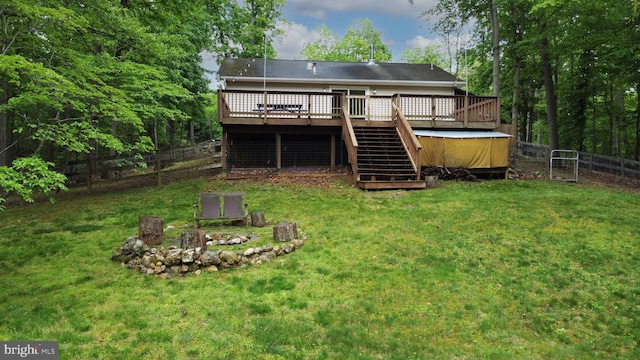 back of house with stairs, an outdoor fire pit, and a wooden deck
