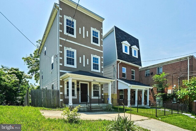5823 Field Pl NE, Washington, DC 20019 - view of front facade with a porch, stucco siding, and fence
