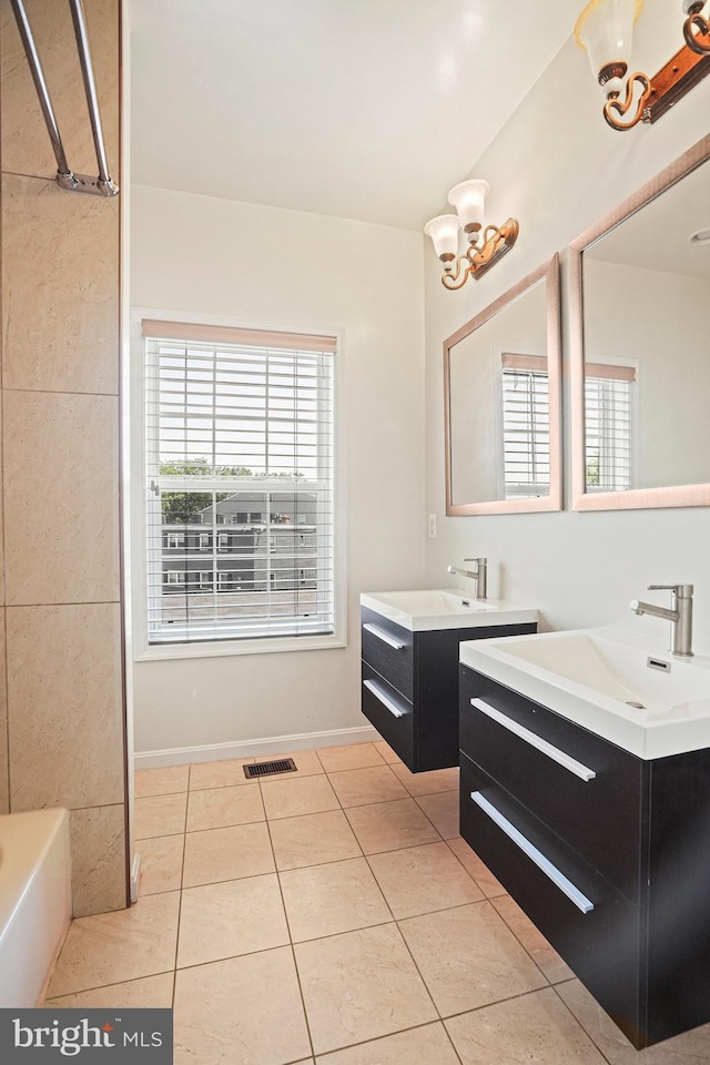5823 Field Pl NE, Washington, DC 20019 - bathroom featuring a sink, visible vents, a tub, tile patterned flooring, and two vanities