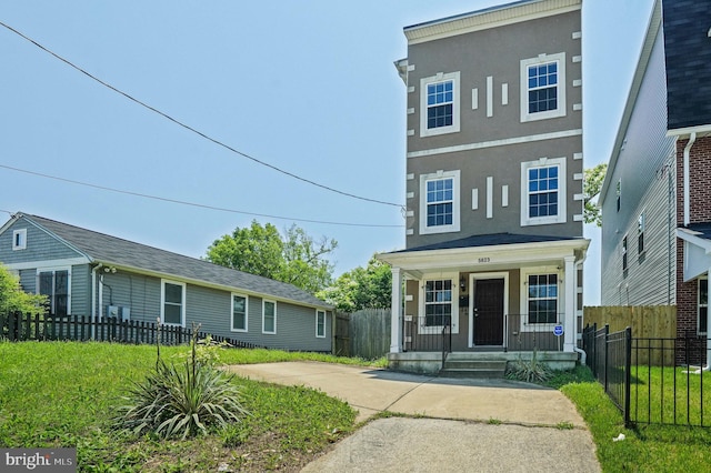 5823 Field Pl NE, Washington, DC 20019 - view of front of house featuring a porch, stucco siding, and fence