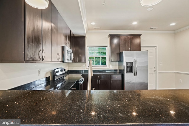 5823 Field Pl NE, Washington, DC 20019 - kitchen with dark stone counters, ornamental molding, visible vents, dark brown cabinets, and appliances with stainless steel finishes