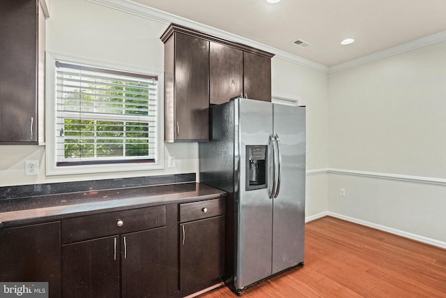 5823 Field Pl NE, Washington, DC 20019 - kitchen featuring visible vents, dark brown cabinetry, light wood finished floors, stainless steel fridge with ice dispenser, and dark countertops