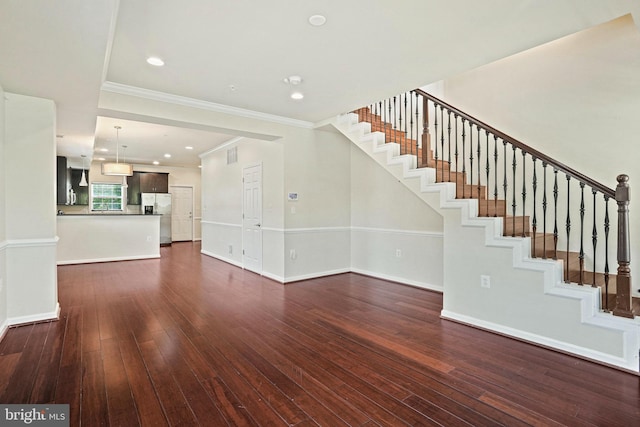 5823 Field Pl NE, Washington, DC 20019 - unfurnished living room with visible vents, dark wood-style flooring, baseboards, ornamental molding, and stairs
