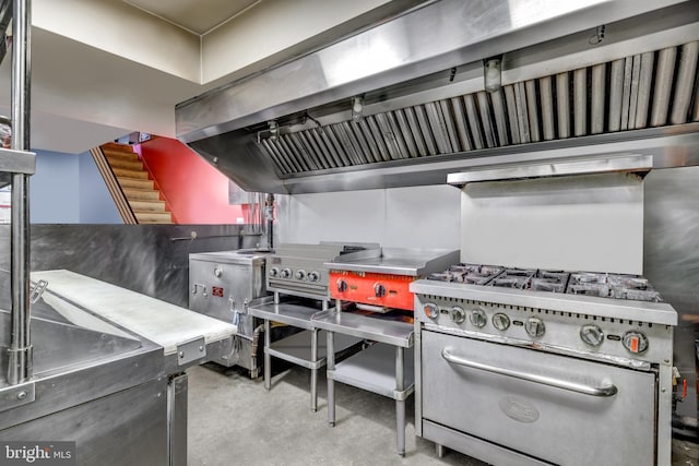 kitchen featuring range hood, concrete flooring, and stainless steel range