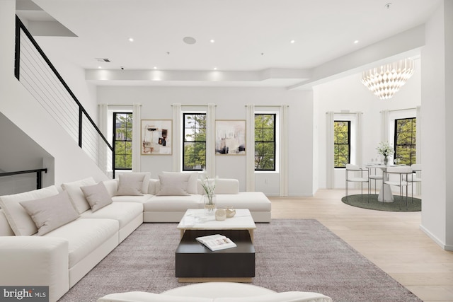 living area with light wood-style flooring, recessed lighting, and a chandelier