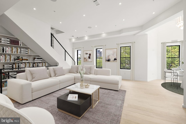 living area with wood finished floors and recessed lighting
