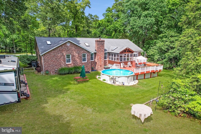 9180 Rolling Meadow Run, Pasadena, MD 21122 - back of property featuring a wooden deck, a chimney, brick siding, and a lawn