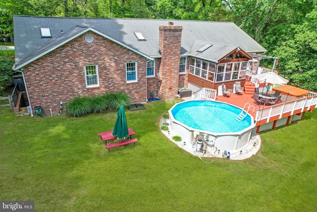 9180 Rolling Meadow Run, Pasadena, MD 21122 - rear view of property with a sunroom, a wooden deck, a chimney, roof with shingles, and a yard