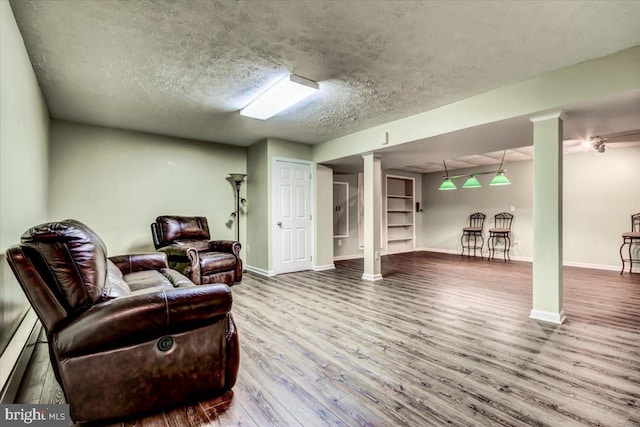 9180 Rolling Meadow Run, Pasadena, MD 21122 - living area featuring wood finished floors, baseboards, a textured ceiling, and a baseboard radiator