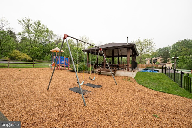 community jungle gym featuring fence and a gazebo
