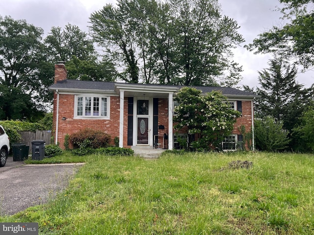 14033 Roanoke St, Woodbridge, VA 22191 - view of front of house with brick siding and a chimney