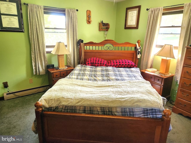 carpeted bedroom with a baseboard heating unit