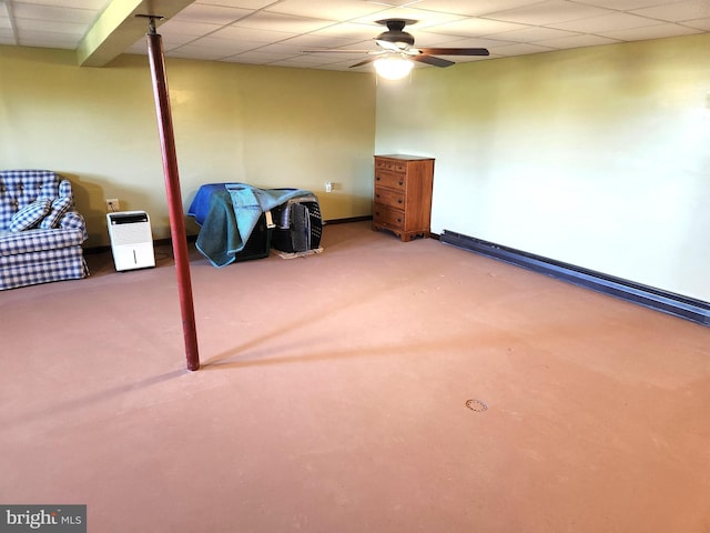 unfurnished bedroom with ceiling fan, carpet floors, baseboards, and a drop ceiling