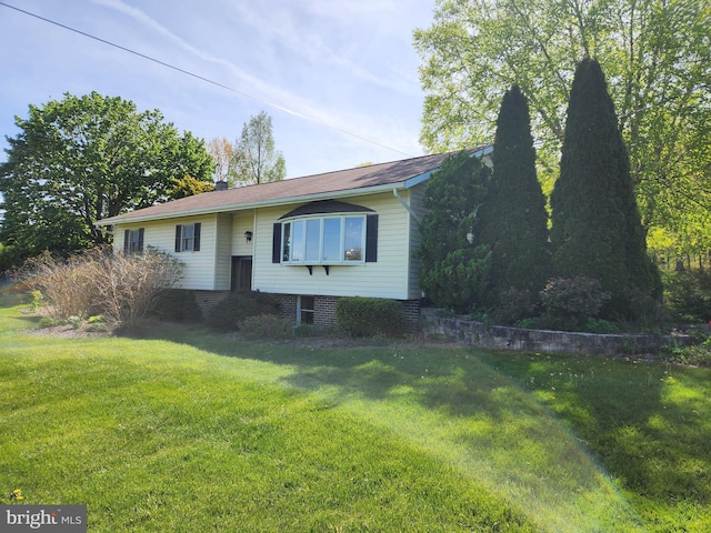 bi-level home with a front lawn
