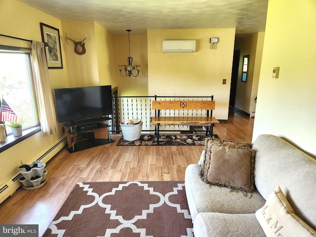 living room featuring an inviting chandelier, a wall mounted air conditioner, and wood finished floors