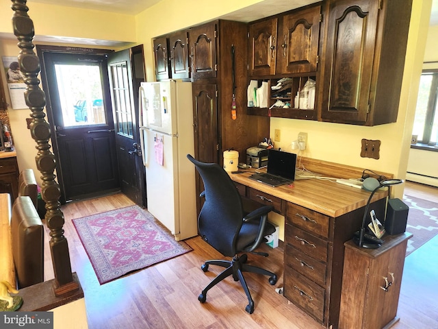 home office with light wood-style floors and a baseboard radiator