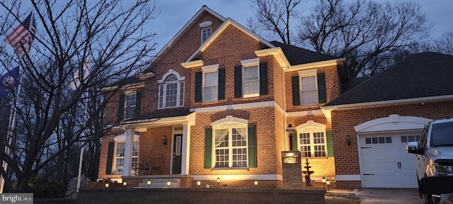 traditional-style house featuring brick siding and an attached garage