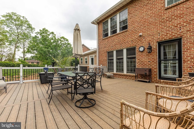 wooden terrace with outdoor dining area