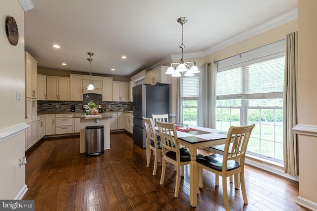 dining space featuring a chandelier, dark wood finished floors, crown molding, and recessed lighting