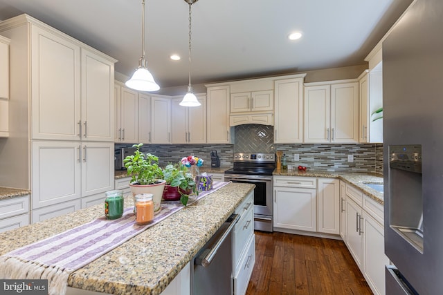 kitchen with stainless steel appliances, dark wood-type flooring, decorative backsplash, hanging light fixtures, and recessed lighting
