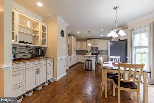 dining room with ornamental molding, dark wood-style flooring, recessed lighting, and a chandelier
