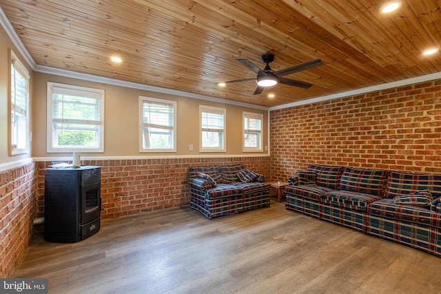 living area with ornamental molding, brick wall, wooden ceiling, wood finished floors, and healthy amount of natural light