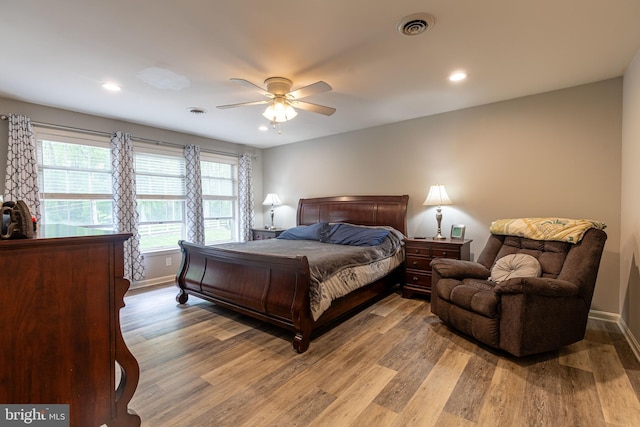 bedroom with light wood-style floors, baseboards, recessed lighting, and a ceiling fan