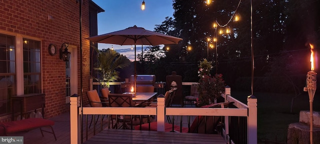 wooden terrace with a fire pit and outdoor dining area