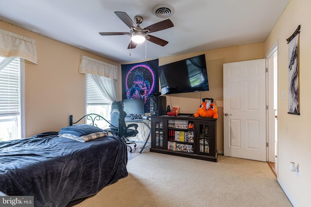 bedroom with carpet, multiple windows, and ceiling fan