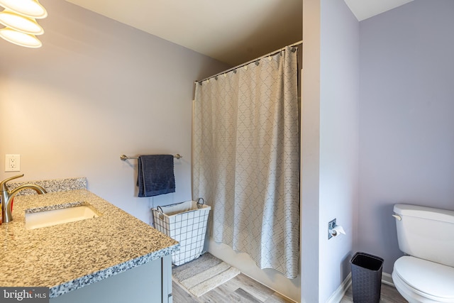 full bathroom with wood finished floors, toilet, vanity, and shower / bathtub combination with curtain