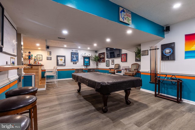 game room featuring wood finished floors, bar, billiards, baseboards, and recessed lighting