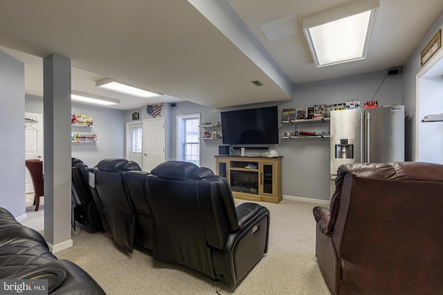 living area with baseboards, a fireplace, and light colored carpet